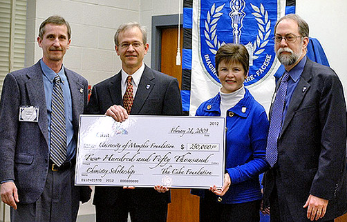 Jim Morse of Ciba (second from left) presents the U of M gift to Dr. Peter Bridson, associate professor and chair of the Department of Chemistry; U of M President Shirley Raines; and Dr. Henry Kurtz, dean of the College of Arts & Sciences.