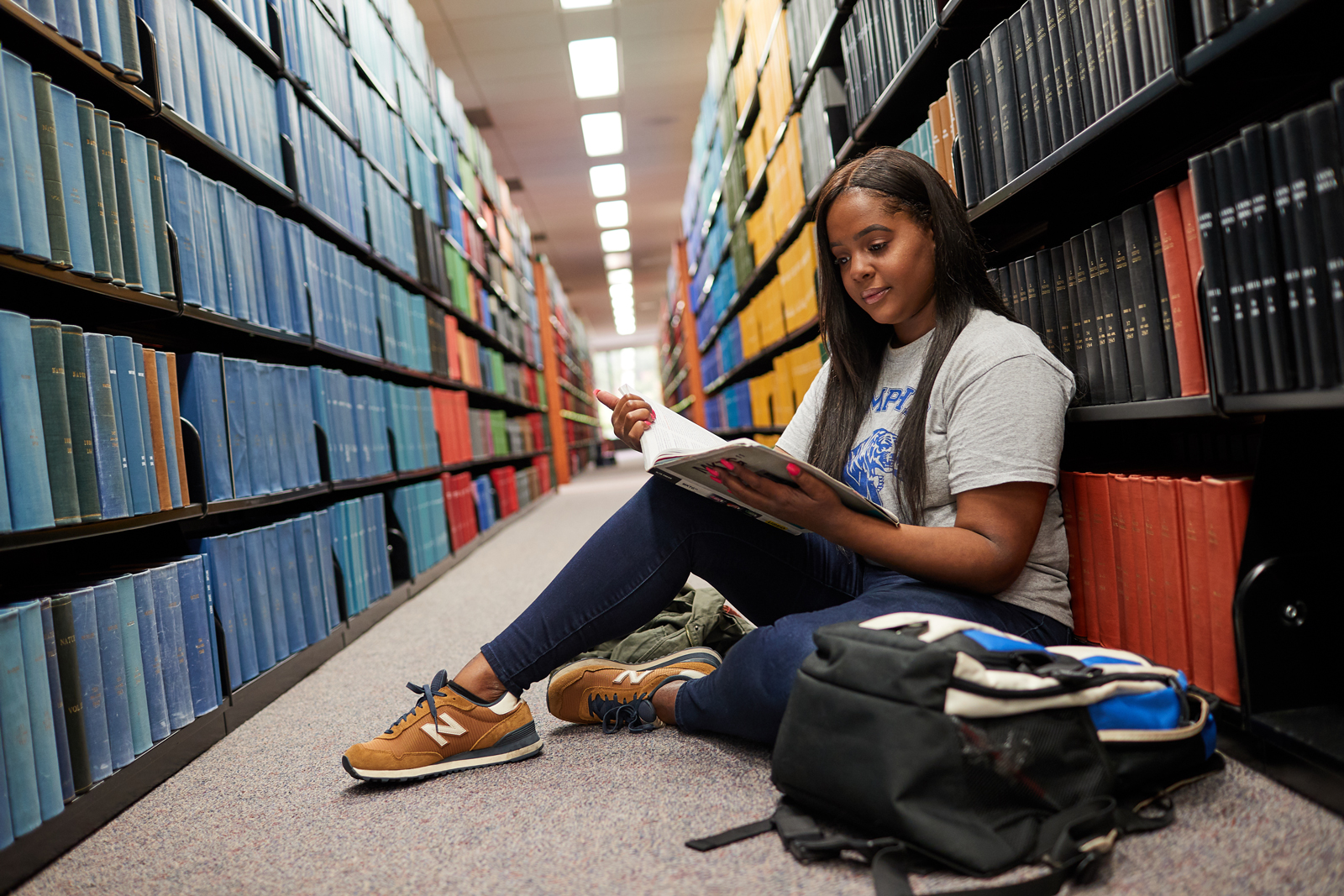 Academic student reading books in the UofM library