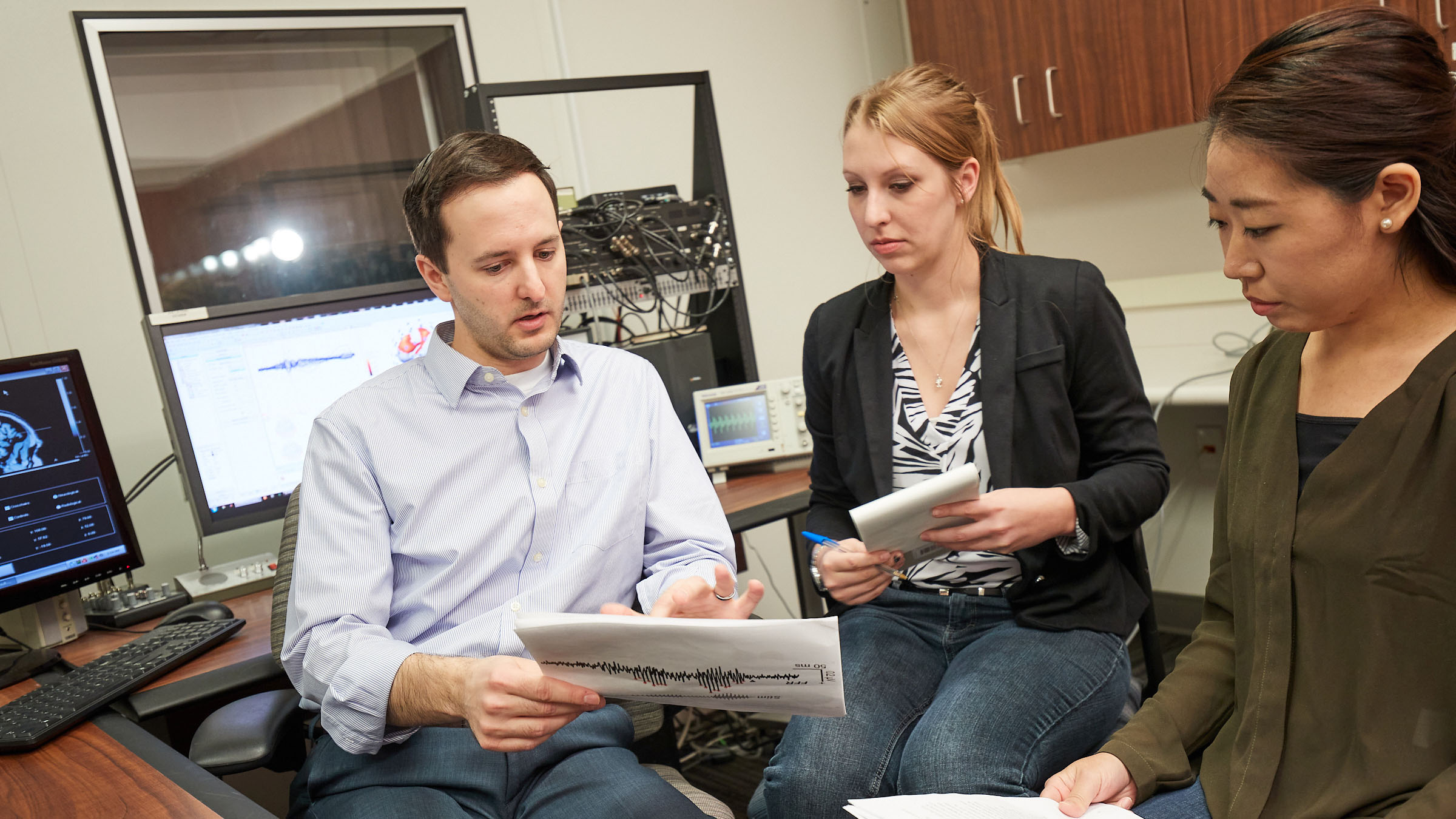 PhD students reading lab report