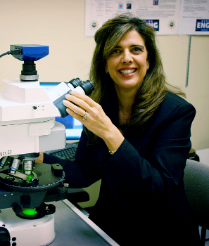 Dr. Preza with a microscope