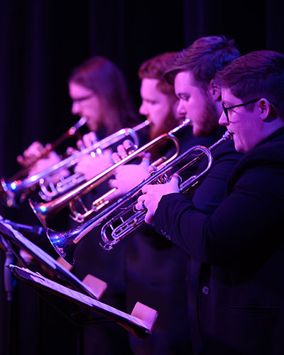 Students playing instruments on stage