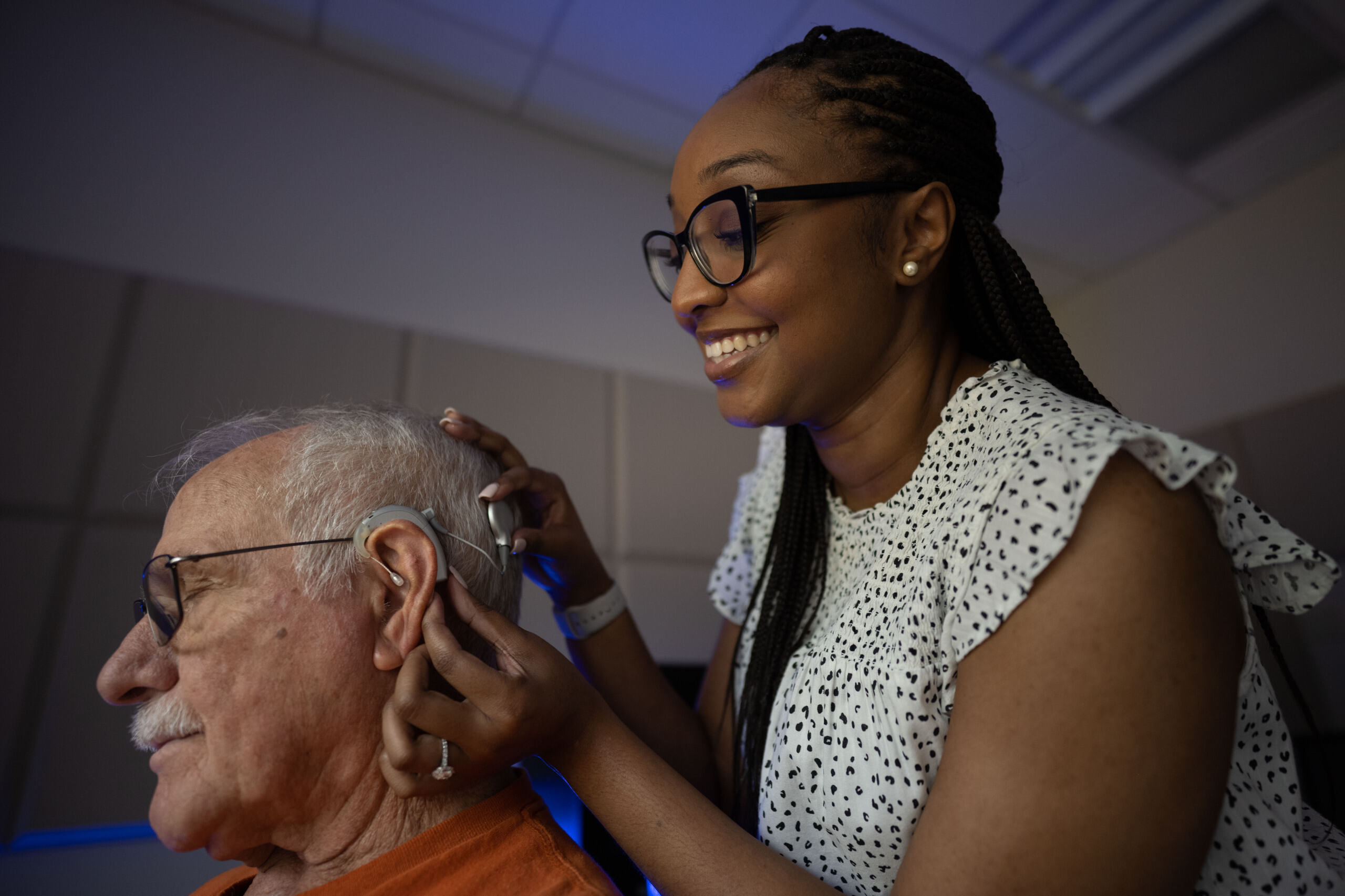 Communication Sciences Disorders student assisting with hearing aid