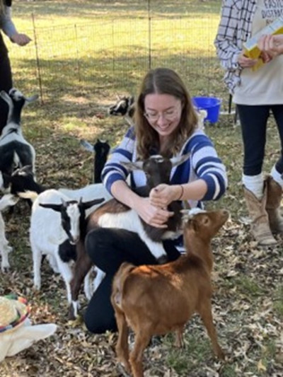 Woman plays with goats