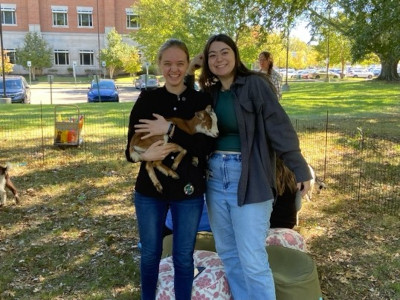 People holding goats