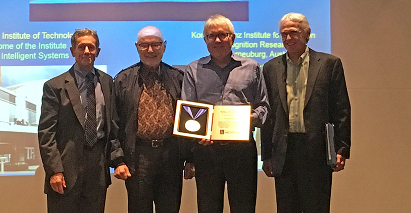 four men standing with award