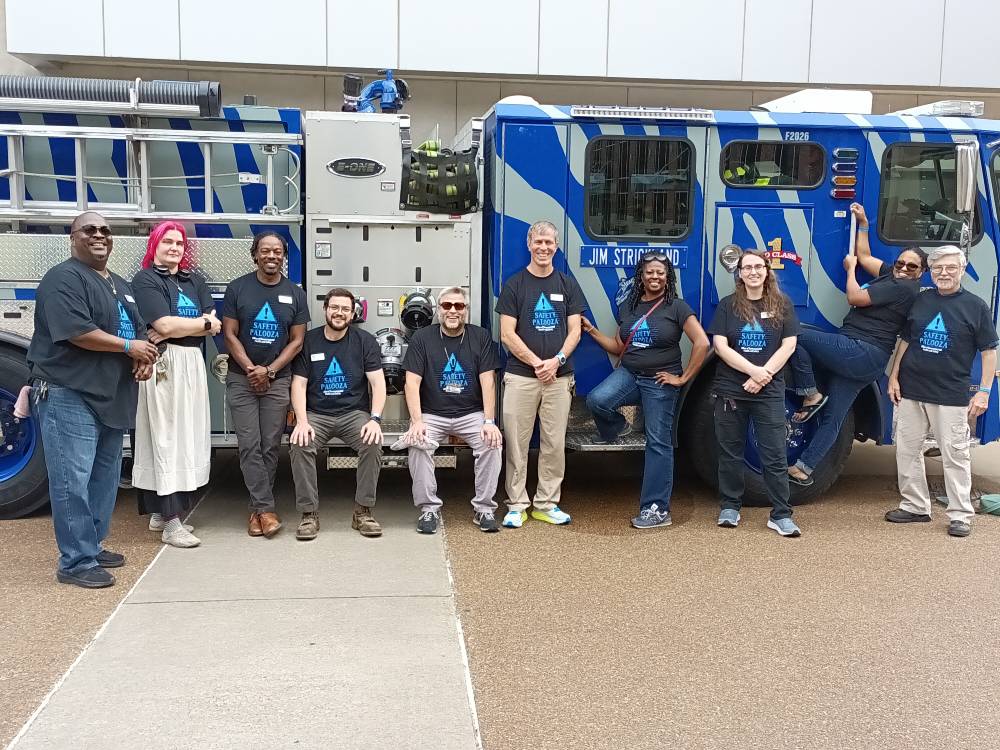 EHS staff posing with the UofM striped fire engine