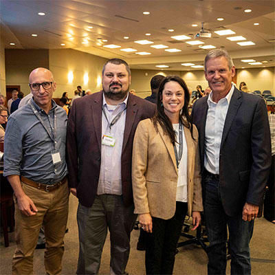 TN Gov. Bill Lee posing with ACRE staff