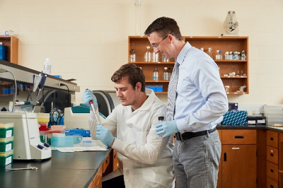 Student and teacher working in lab