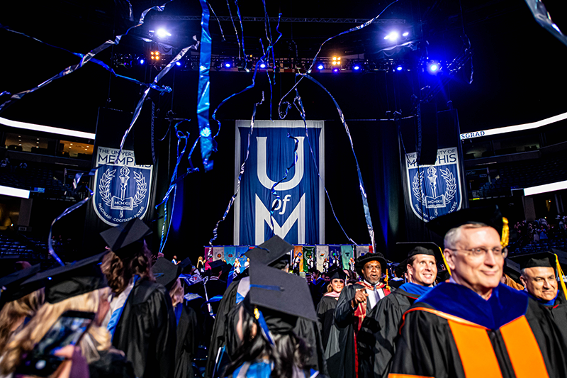 graduation celebration picture with Dean Okoli in background