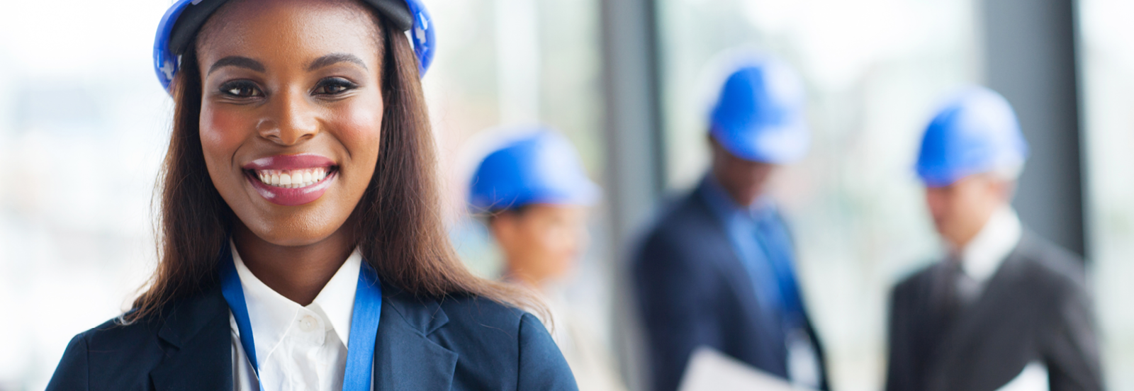 picture of woman in a hard hat with people in the background