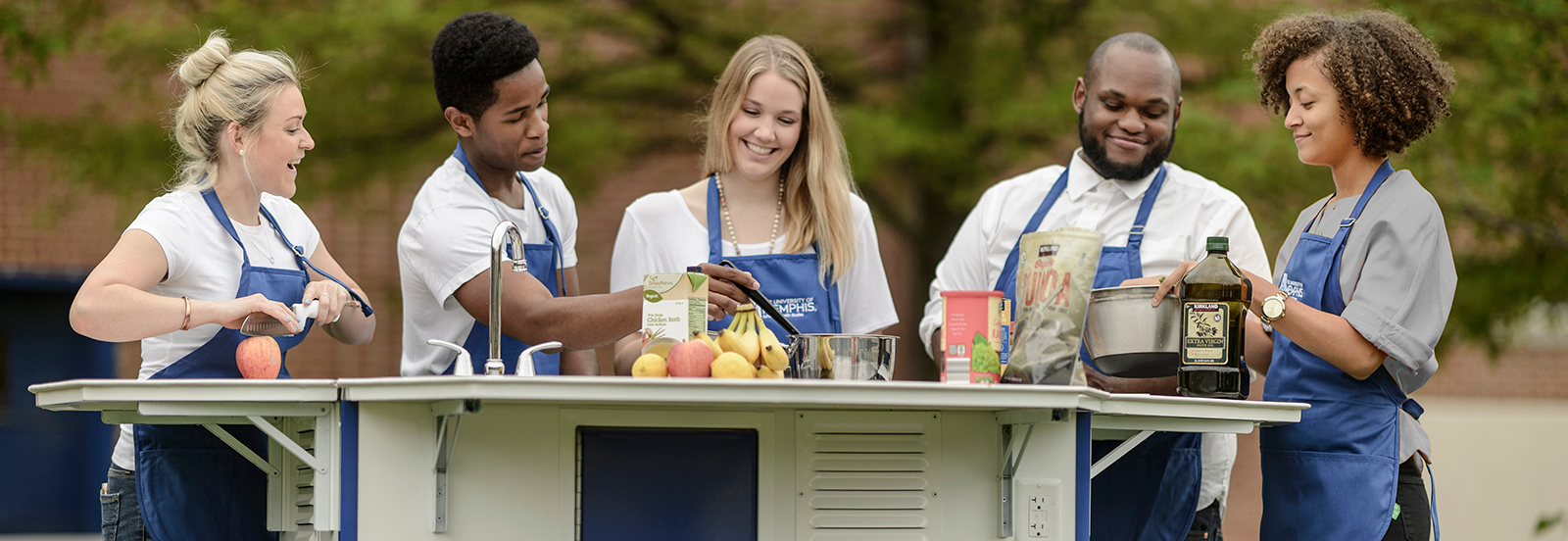 students preparing food at outdoor health kitchen