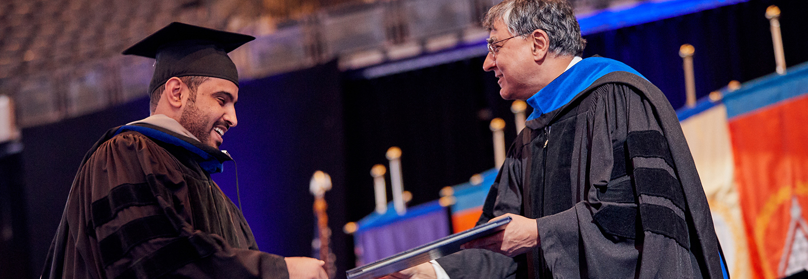 student receiving diploma at graduation