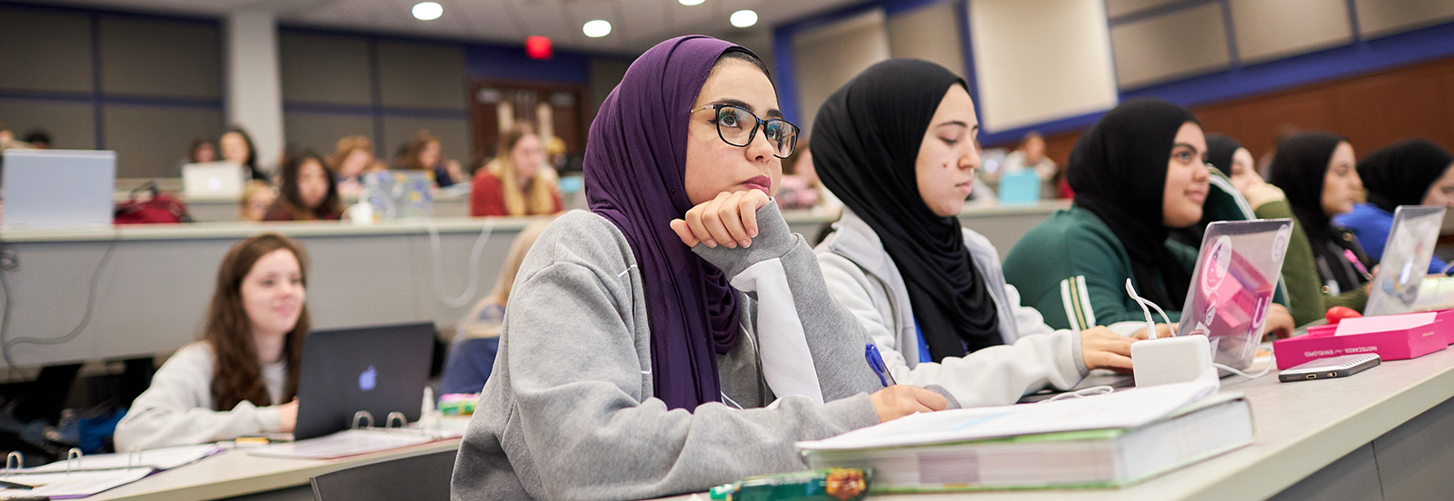 Nursing Students in an auditorium during a lecture. 