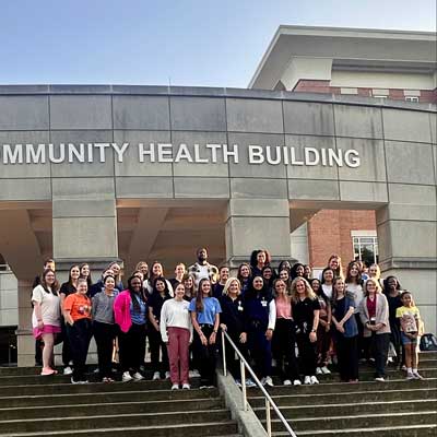 Michael Kidd-Gilchrist Meets poses with teachers and students outside the UofM School of Communication Sciences and Disorders