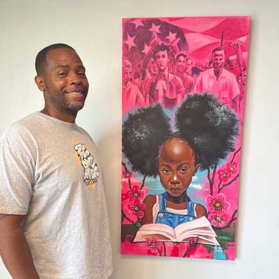 Artist D.Weaver with his art piece called The Story is Not Over