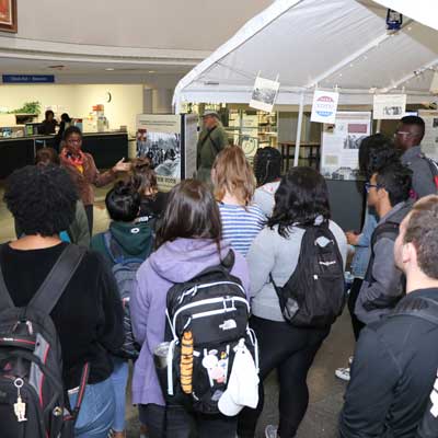 Daphene R. McFerren discusses "Tent City" display with students