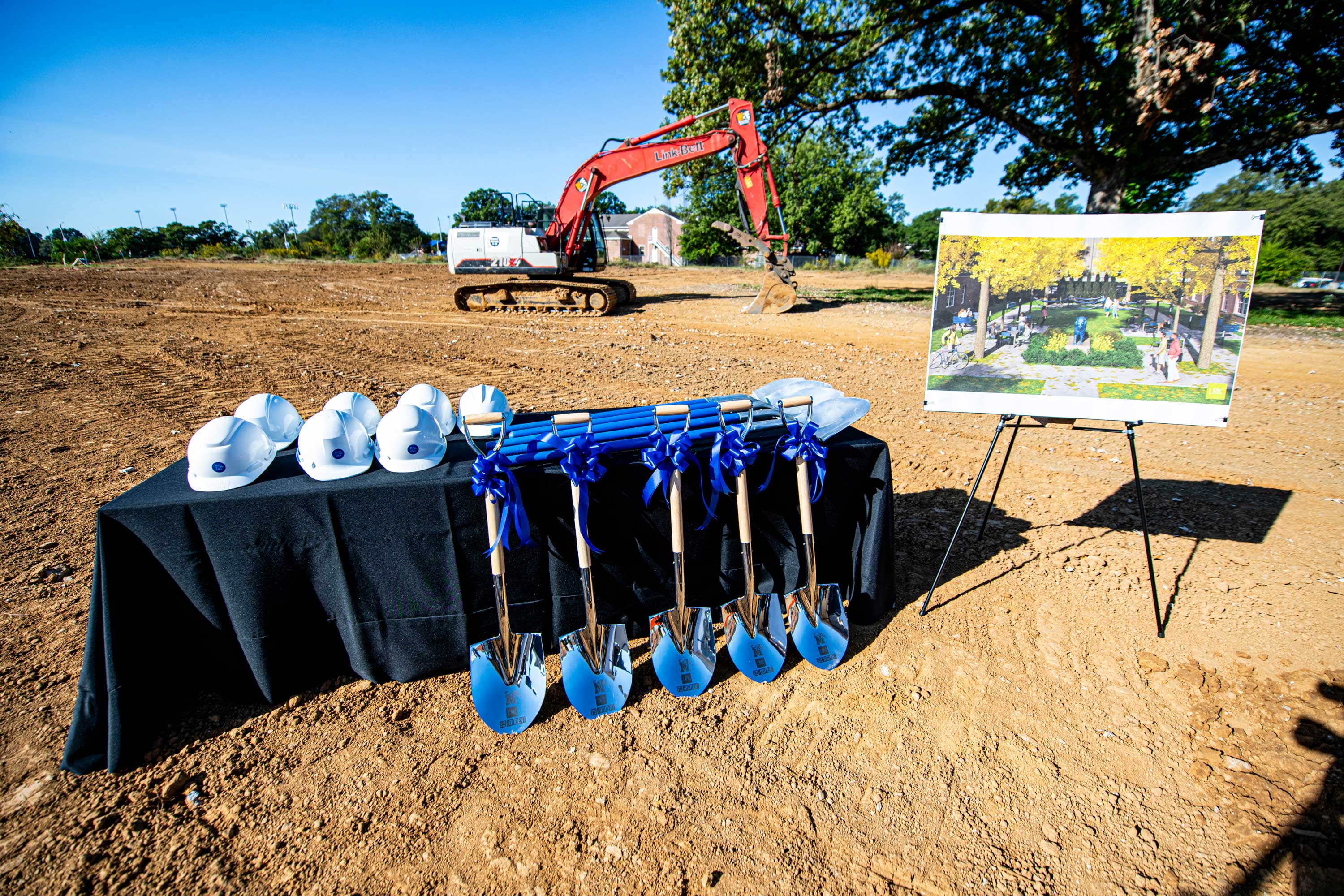 Ceremonial shovels with rendering of new Park Ave. campus apartments