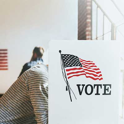 Person voting at a voting booth