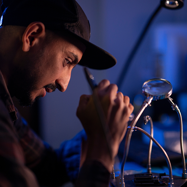 Researcher is soldering in a lab