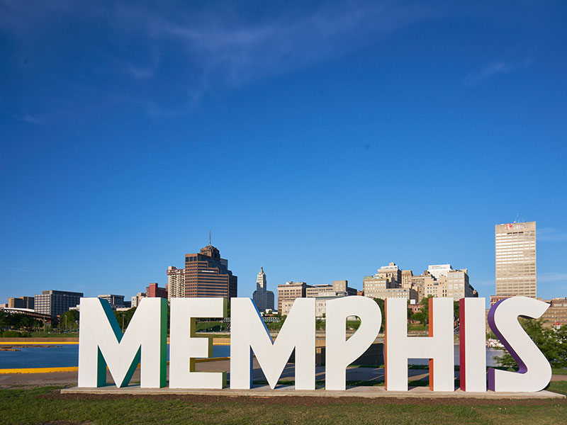 The word Memphis with downtown Memphis in the background