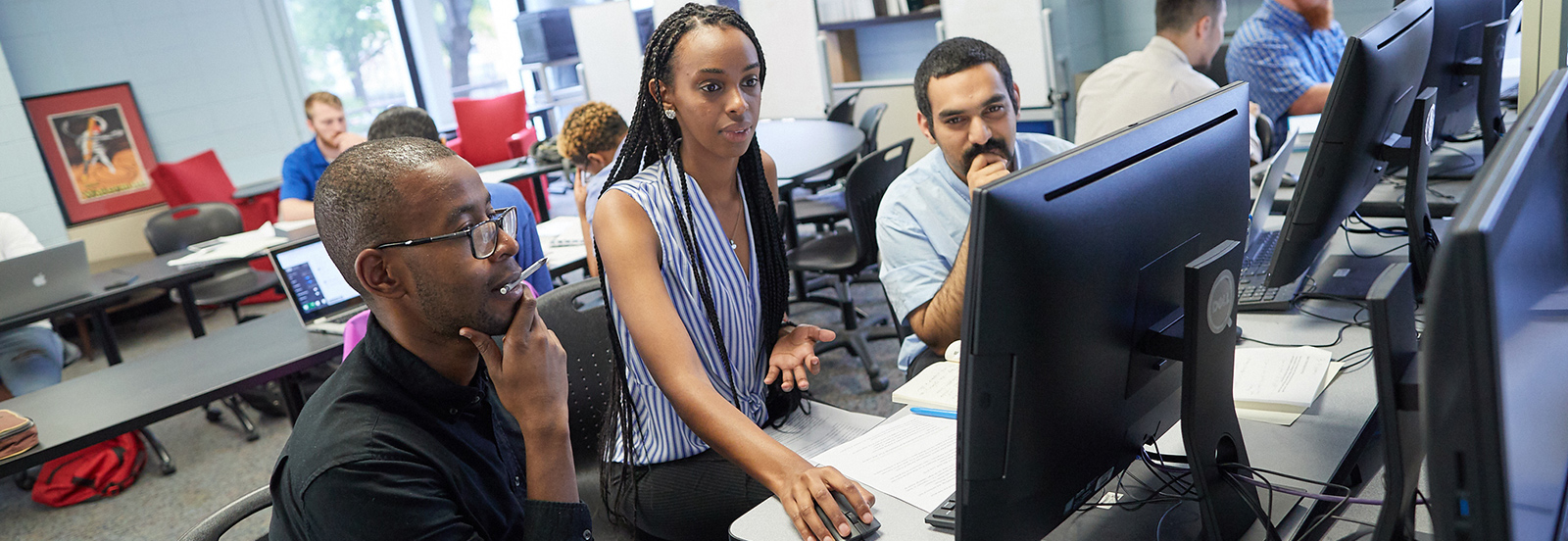 students with teacher at computer