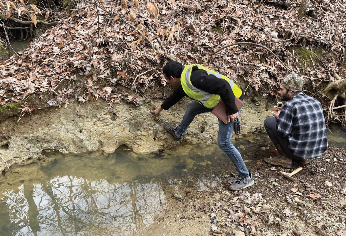 A field photo of Narayan Adhikari and Jeffery Collins investigating an outcrop on the Leapwood 7.5-minute quadrangle in western Tennessee. 