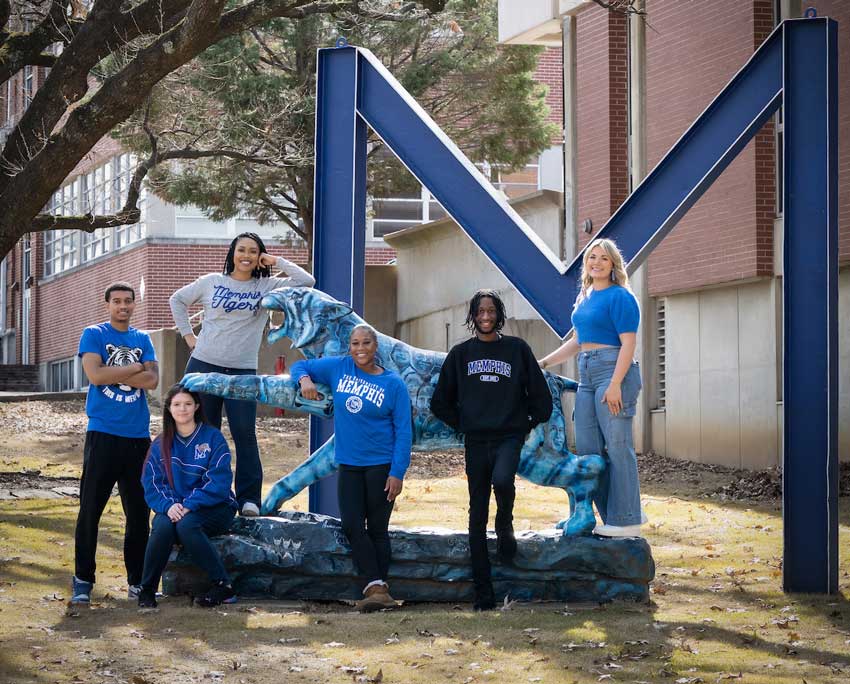 Six UofM students pose on campus