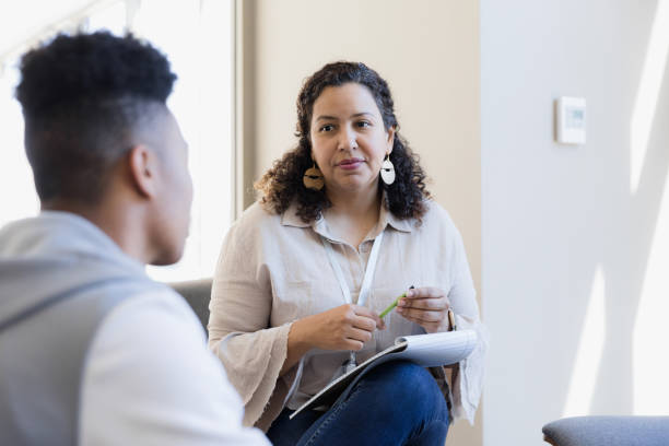 female professional presenting to group of colleagues