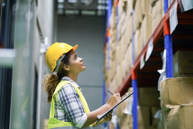 female overseeing supplies and managing a warehouse