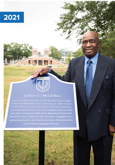 Luther C. McClellan in 2021 in front of the marker of the Luther C. McClellan Alumni Mall